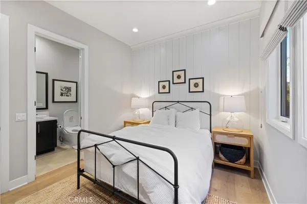 a bedroom with a bed and a lamp on table