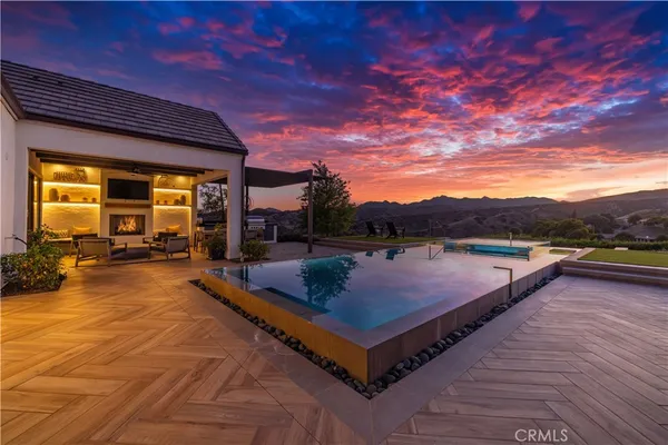 a view of a swimming pool with seating space