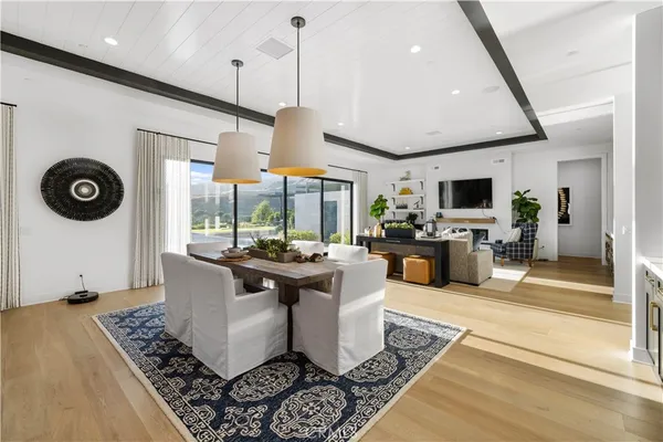 a living room with furniture a rug and a view of kitchen
