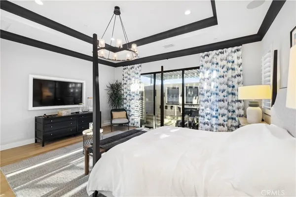 a bedroom with a bed window and a flat screen tv