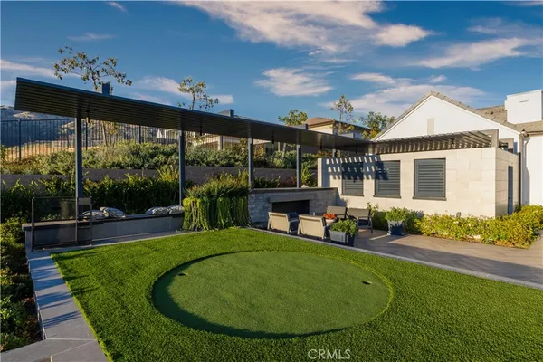 a view of a house with a backyard porch and sitting area