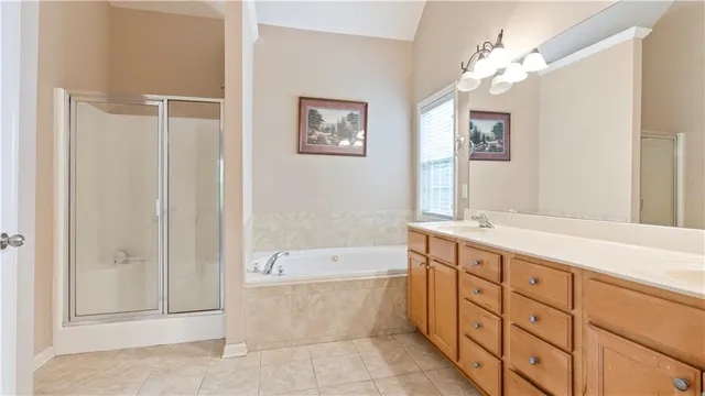 a bathroom with a tub sink and mirror