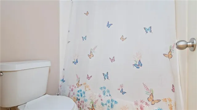 a white toilet sitting next to a bathroom sink
