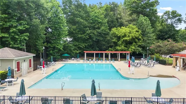 a view of a house with pool porch and chairs