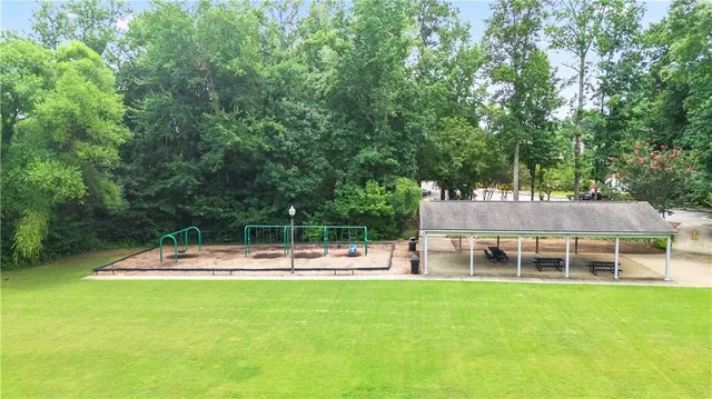 a view of a house with a backyard and a patio