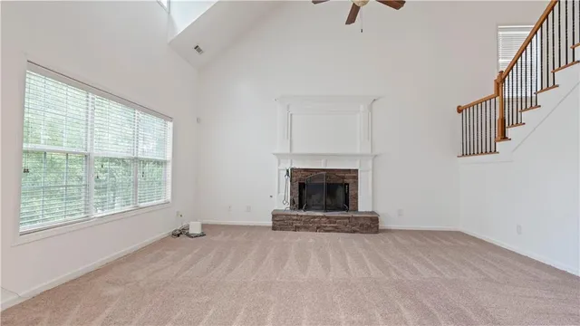 a view of empty room with a fireplace and window