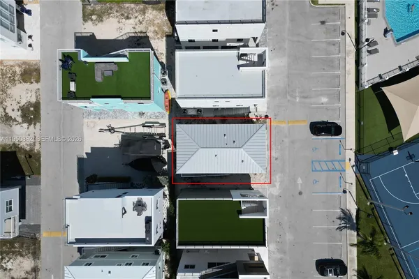 an aerial view of a house with a yard