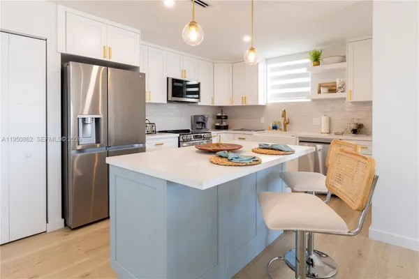 a kitchen with a refrigerator a stove a sink and a refrigerator