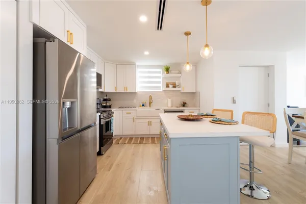 a kitchen with a sink stove and microwave