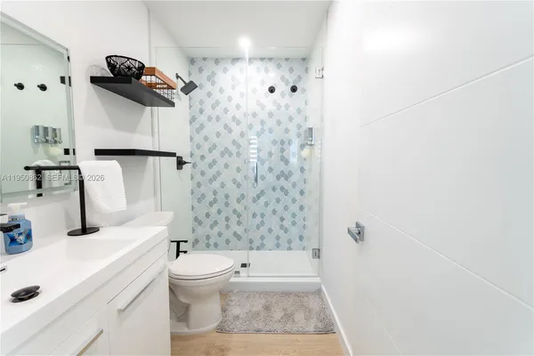 a bathroom with a sink toilet and shower