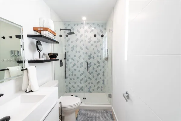 a bathroom with a sink toilet and shower