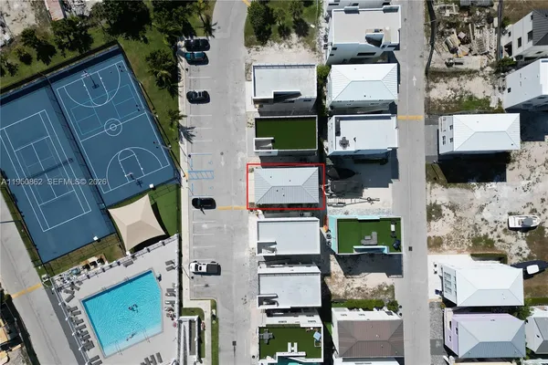 an aerial view of residential houses with outdoor space
