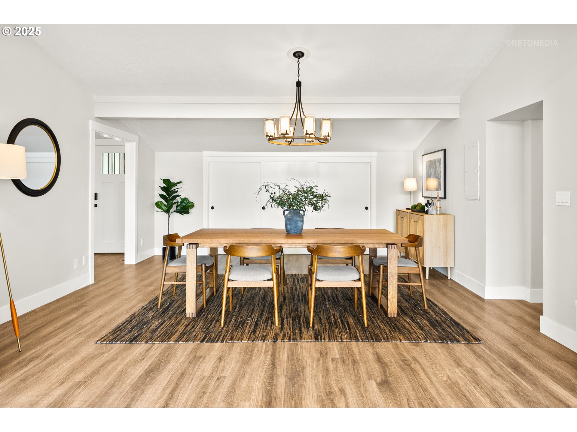 22645 Southwest Chapman Road Sherwood, OR 97140 - Photo 11 of 48 a dining room with wooden floor a chandelier a wooden table and chairs