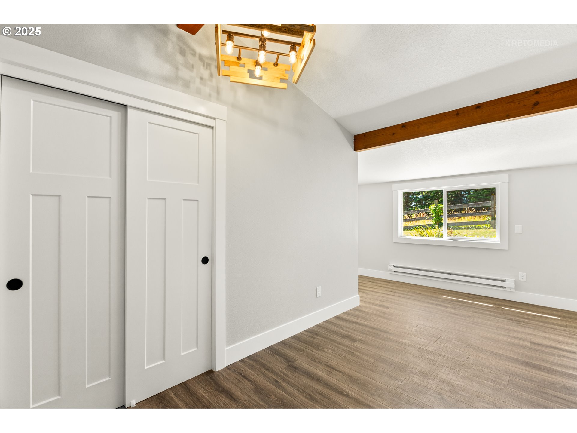 22645 Southwest Chapman Road Sherwood, OR 97140 - Photo 19 of 48 a view of an empty room with window and wooden floor
