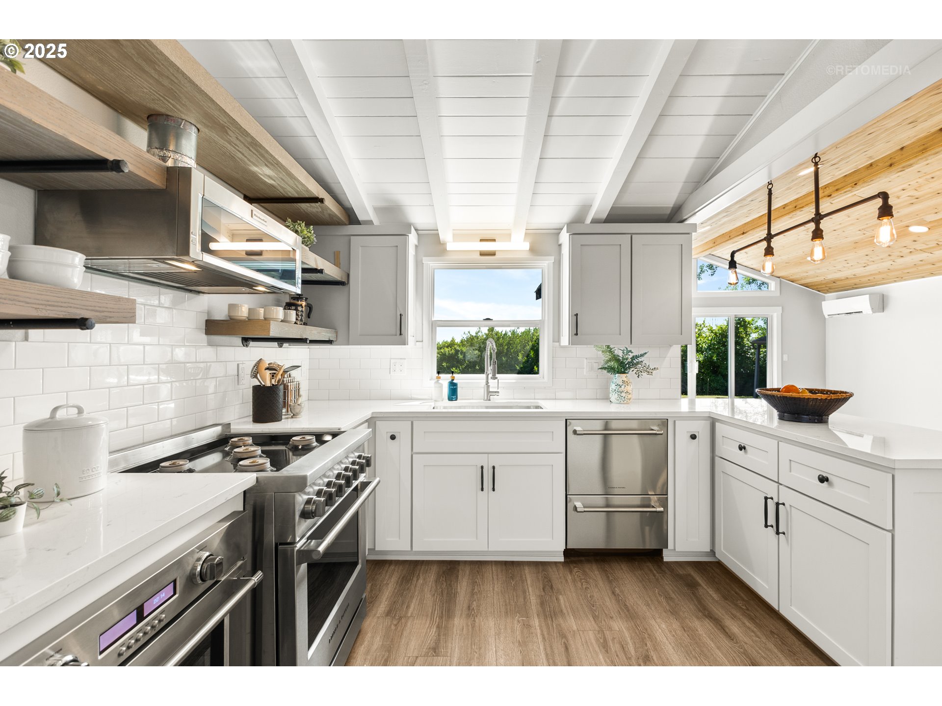 22645 Southwest Chapman Road Sherwood, OR 97140 - Photo 7 of 48 a kitchen with white cabinets a sink dishwasher and a stove with wooden floor