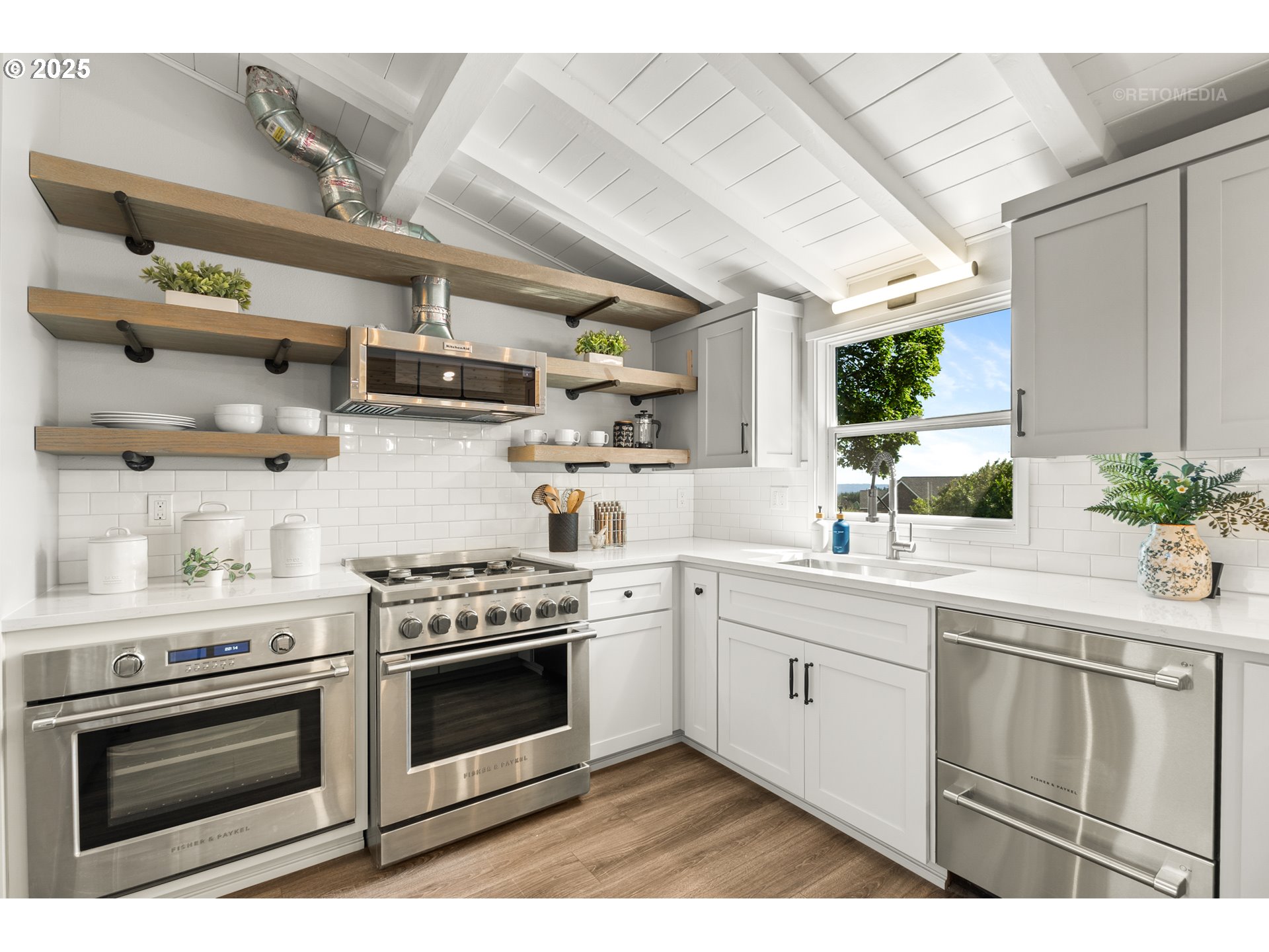 22645 Southwest Chapman Road Sherwood, OR 97140 - Photo 8 of 48 a kitchen with stainless steel appliances granite countertop a sink a stove and cabinets
