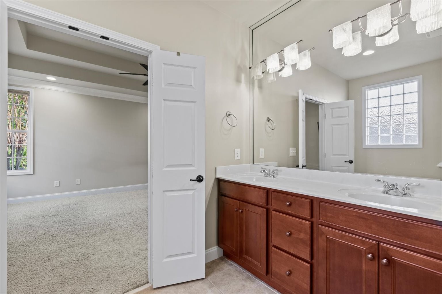 1114 Chickadee Circle Hermitage, TN 37076 - Photo 20 of 39 a spacious bathroom with a granite countertop sink a mirror and a shower