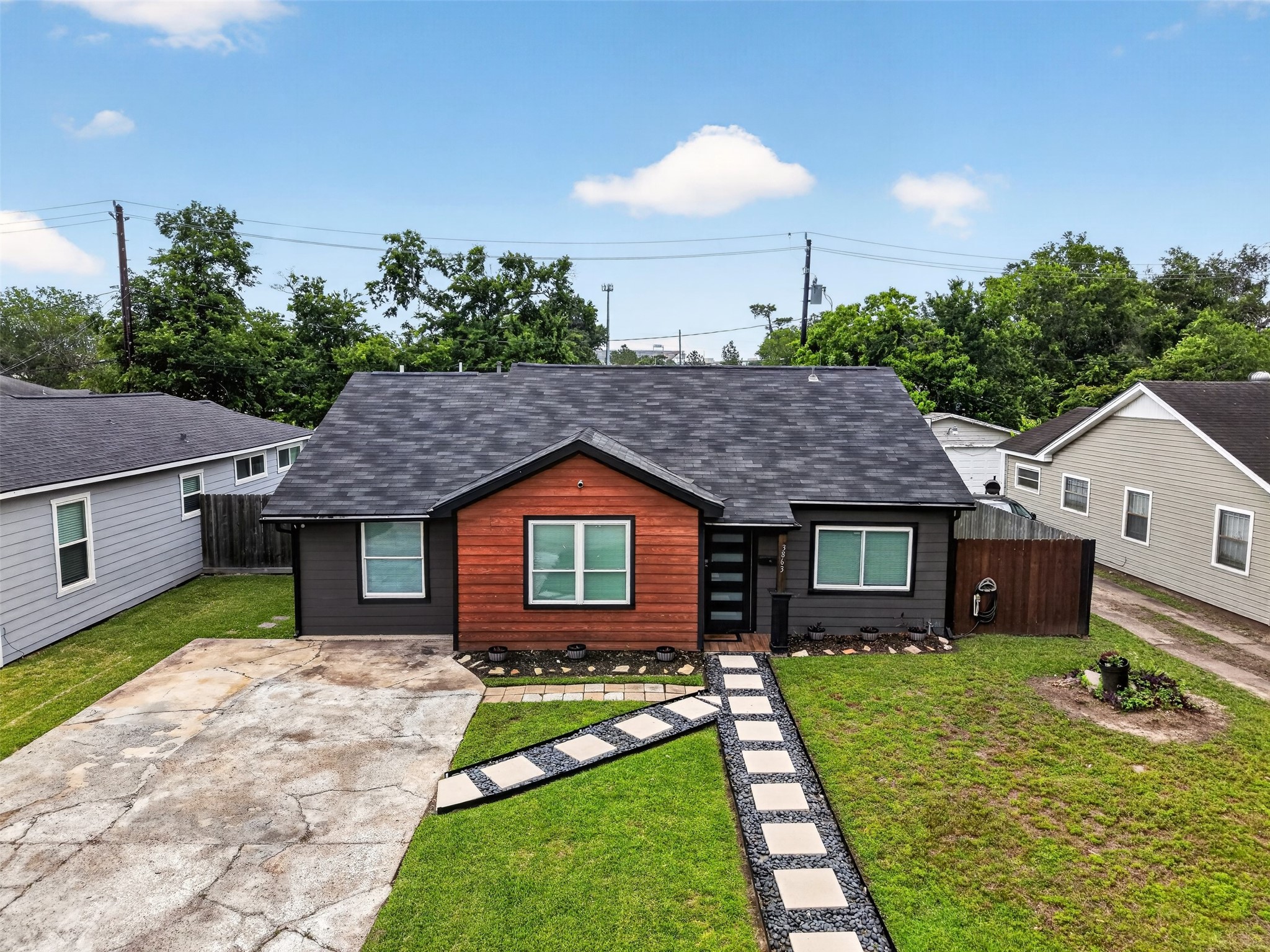 3863 Arbor Street Houston, TX 77004 - Photo 1 of 35 a front view of a house with a garden and yard