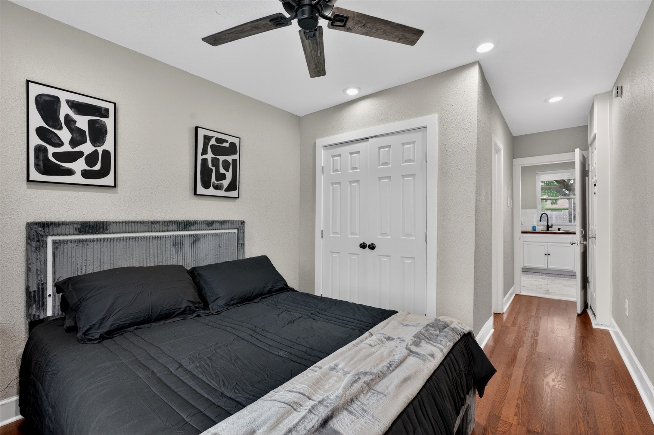 3863 Arbor Street Houston, TX 77004 - Photo 21 of 35 a bedroom with a bed and wooden floor