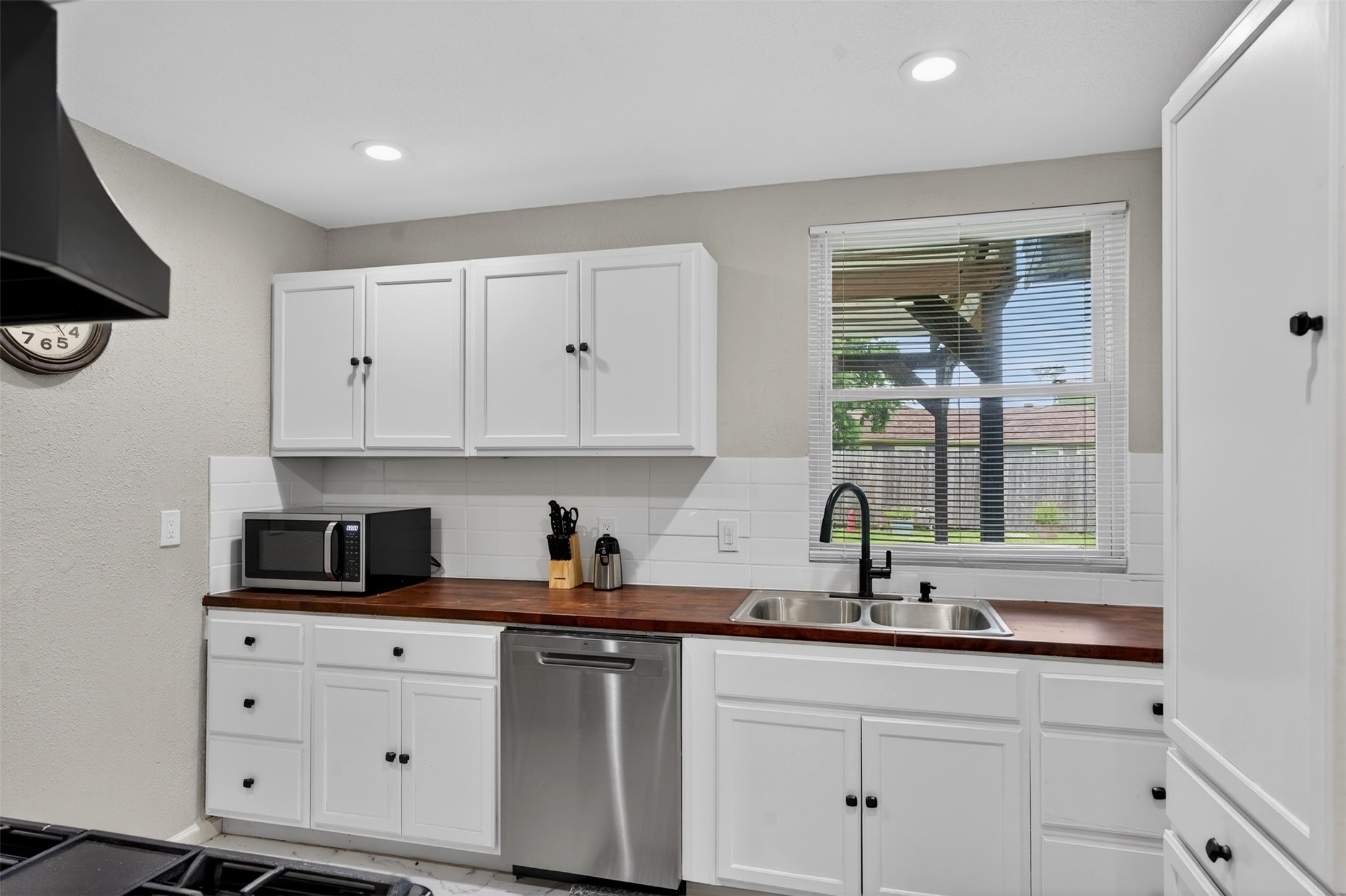 3863 Arbor Street Houston, TX 77004 - Photo 24 of 35 a kitchen with white cabinets and a sink