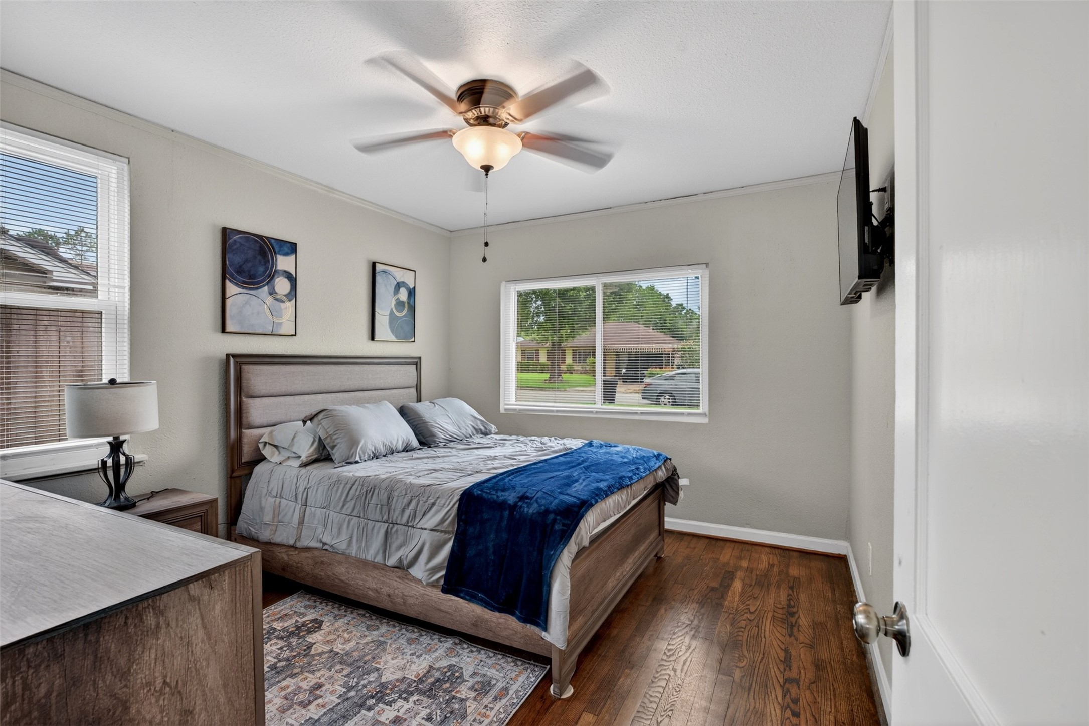 3863 Arbor Street Houston, TX 77004 - Photo 30 of 35 a bedroom with a large bed and a chandelier