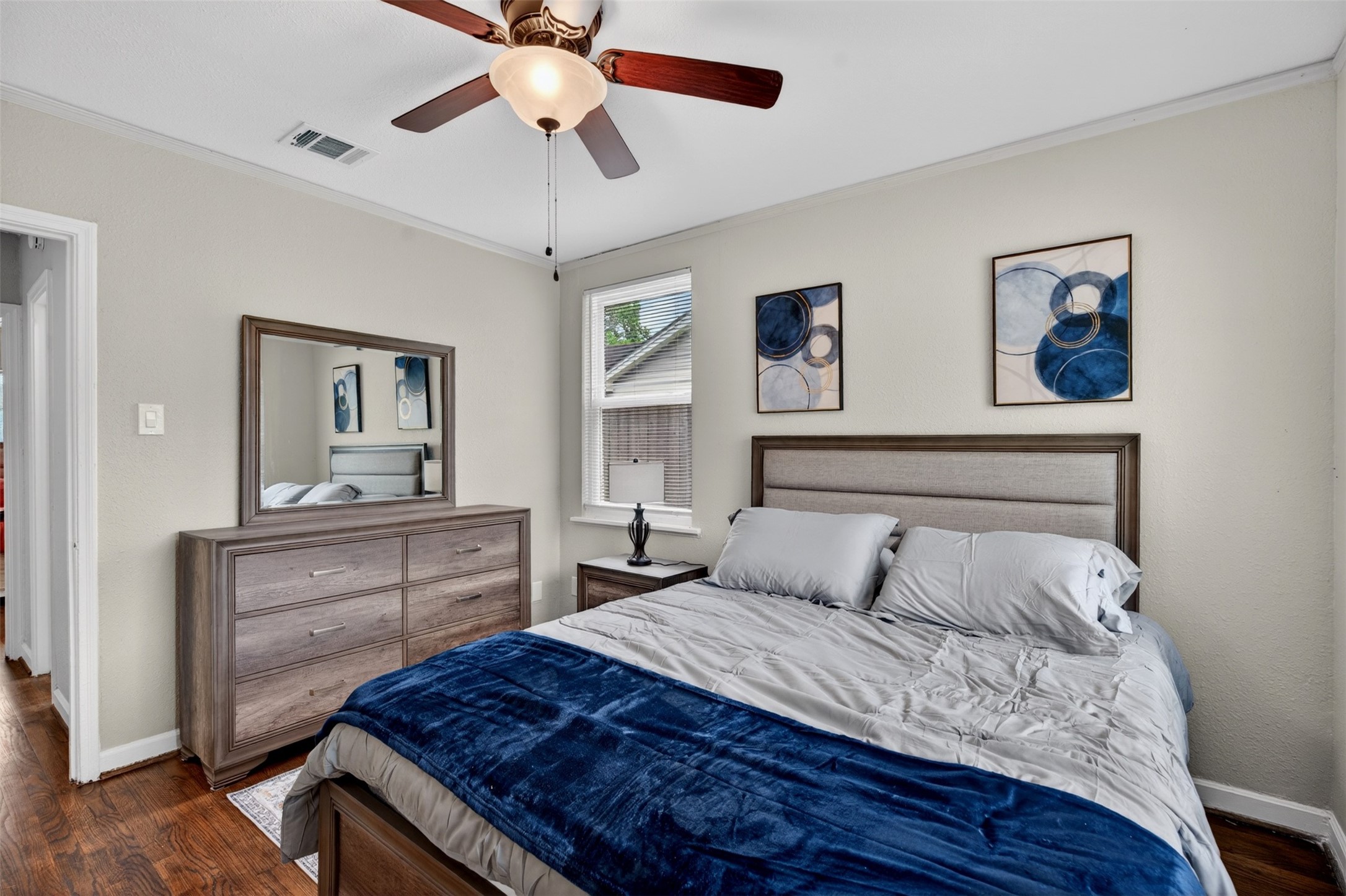 3863 Arbor Street Houston, TX 77004 - Photo 31 of 35 a bedroom with a large bed and a chandelier