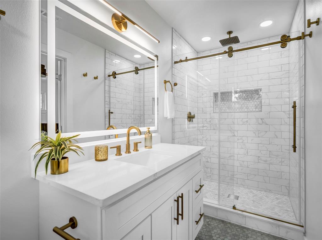 2371 Chart Drive Dallas, TX 75228 - Photo 20 of 31 a bathroom with a sink a mirror and a shower