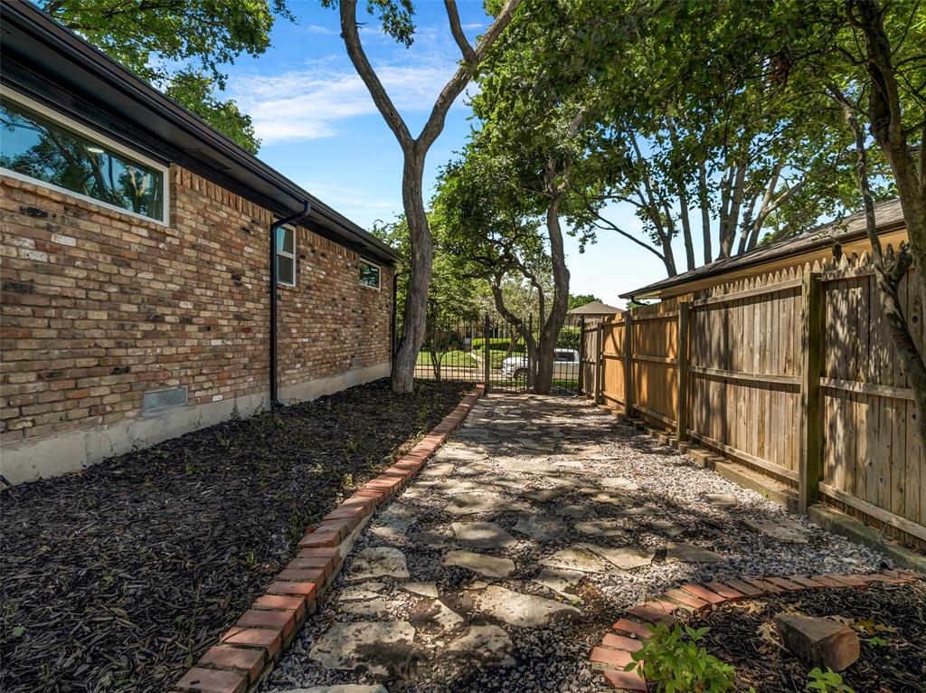 2371 Chart Drive Dallas, TX 75228 - Photo 26 of 31 a backyard of a house with wooden fence and large trees