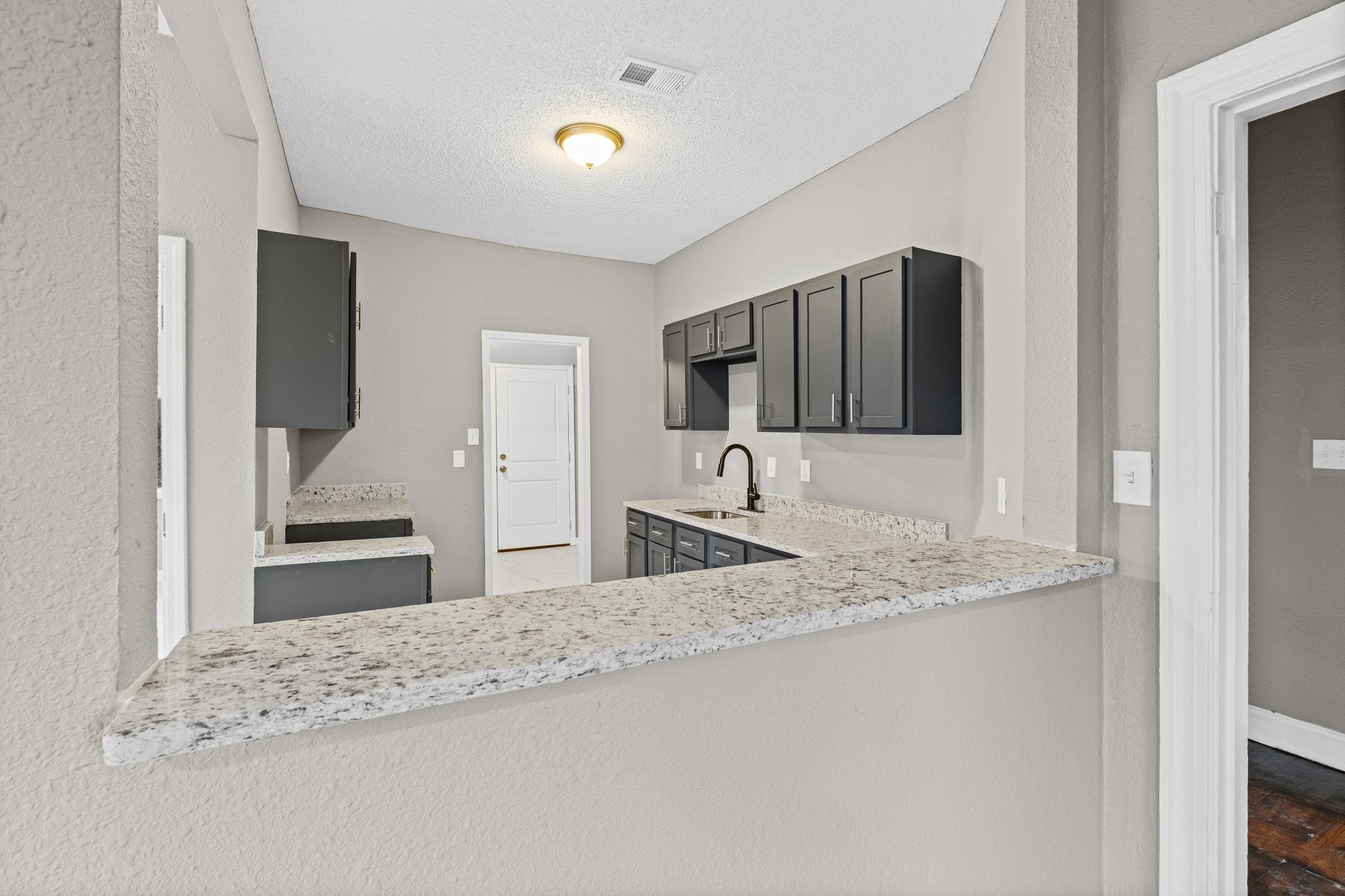 1503 Swift Street Memphis, TN 38109 - Photo 11 of 17 a bathroom with a granite countertop sink and a mirror