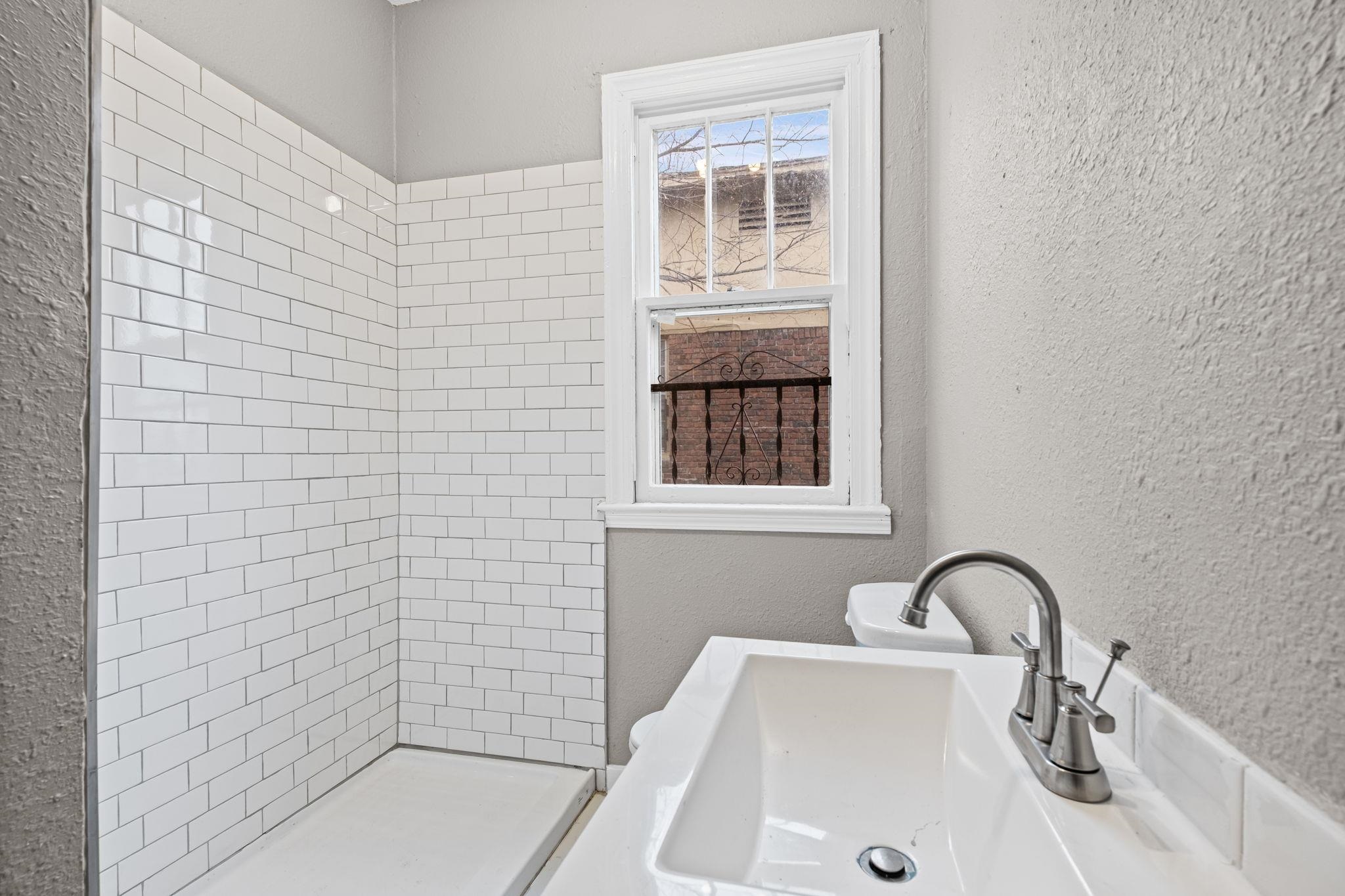 1503 Swift Street Memphis, TN 38109 - Photo 12 of 17 a bathroom with a sink and a bathtub