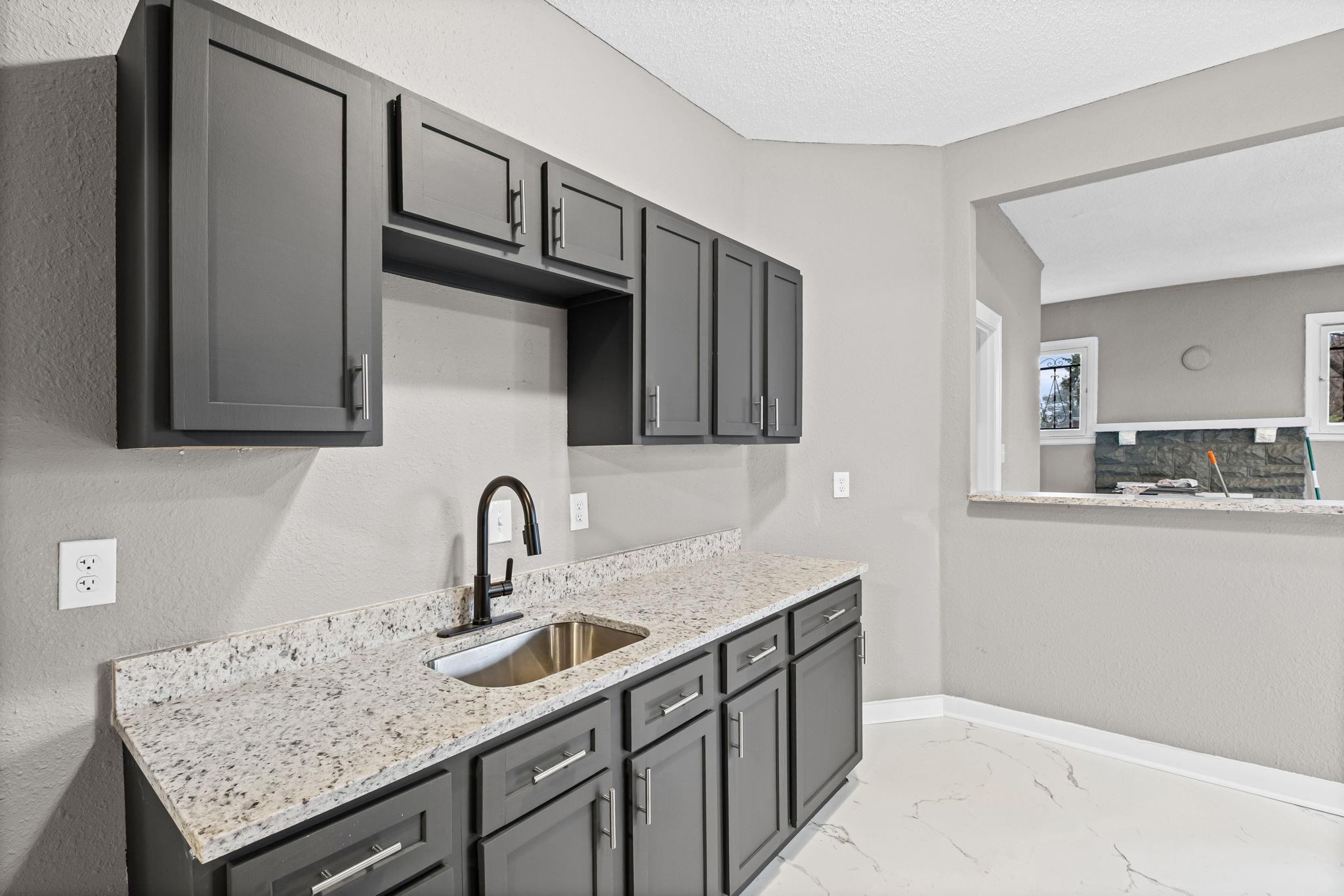 1503 Swift Street Memphis, TN 38109 - Photo 14 of 17 a kitchen with granite countertop a sink and cabinets