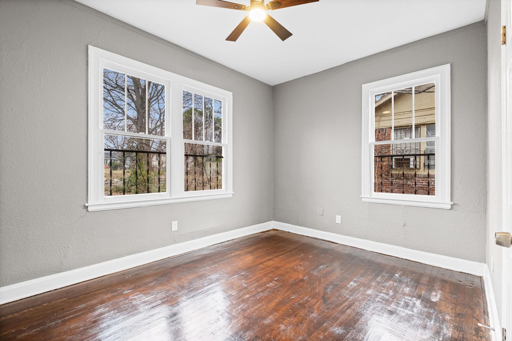 1503 Swift Street Memphis, TN 38109 - Photo 14 of 17 a view of an empty room with a window and wooden floor