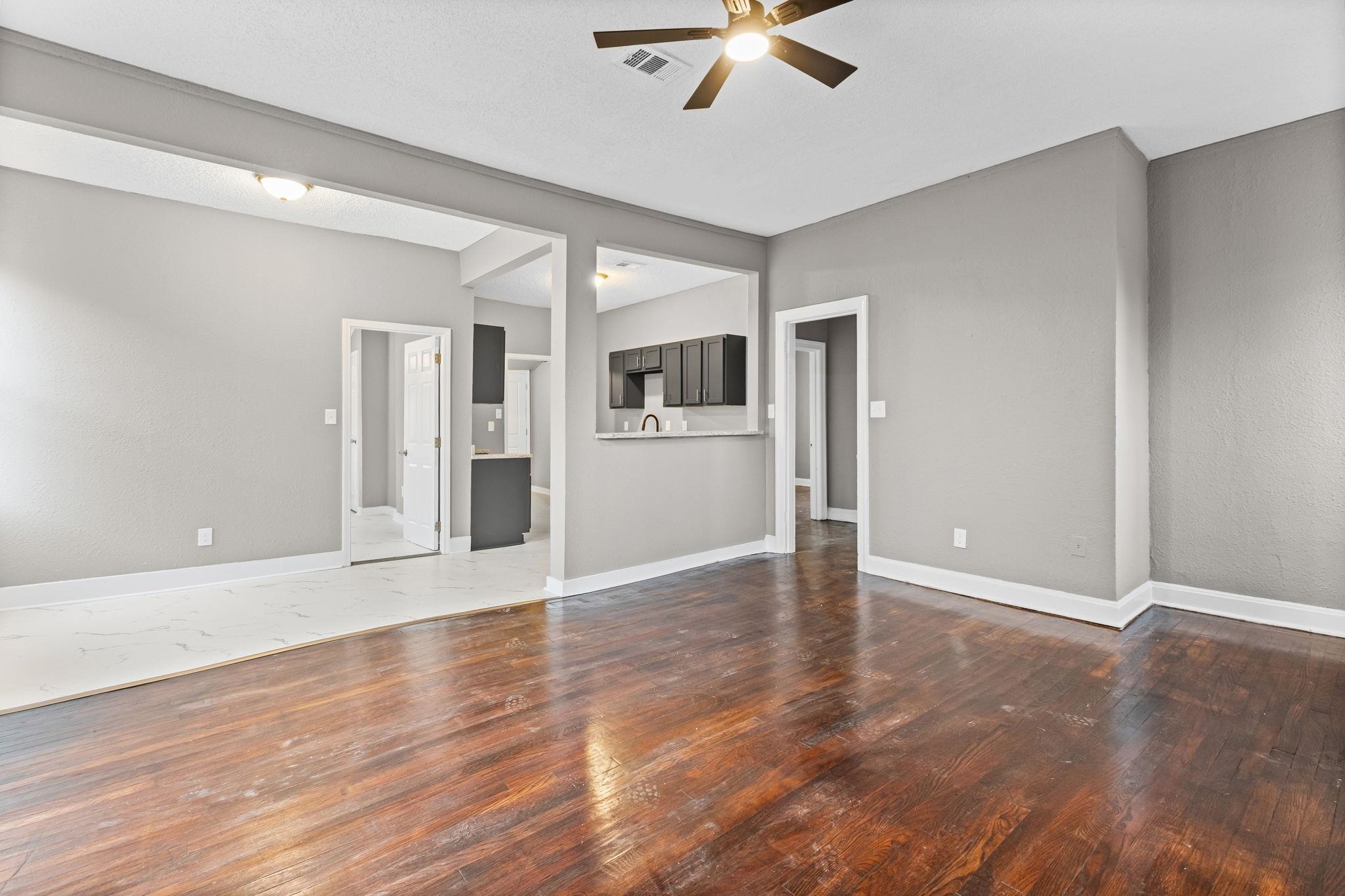 1503 Swift Street Memphis, TN 38109 - Photo 9 of 17 an empty room with wooden floor and windows
