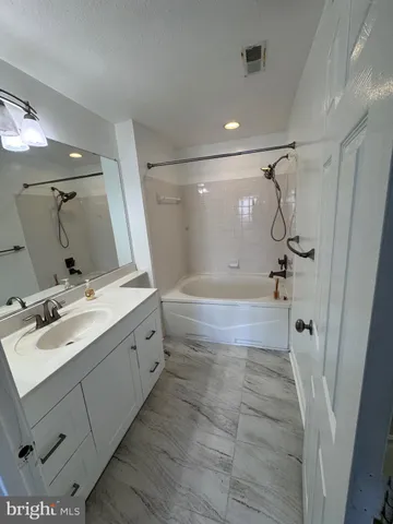 a bathroom with a double vanity sink mirror double and shower