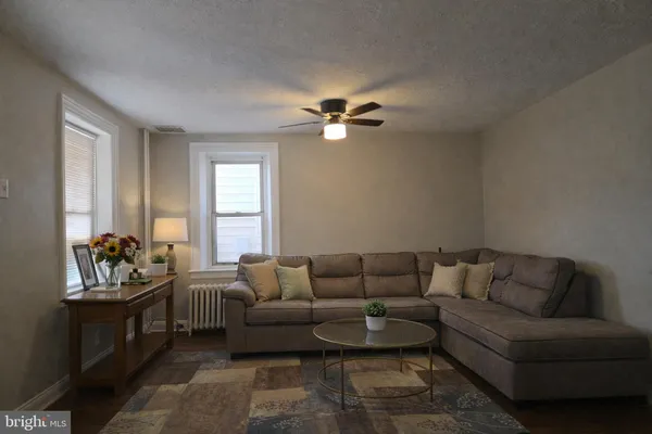a living room with furniture and a chandelier