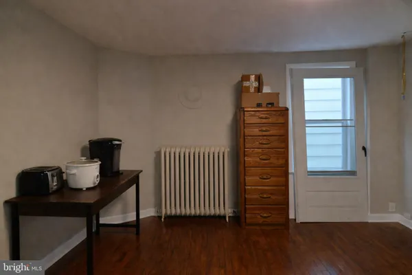 a view of a workspace with furniture and wooden floor