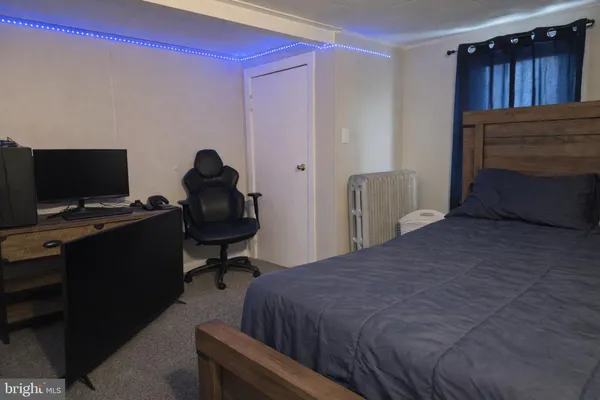 a bedroom with a bed and a television