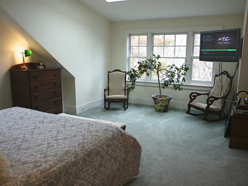 56 Riverside Lane Riverside, CT 06878 - Photo 8 of 11 a bedroom with furniture and a large window