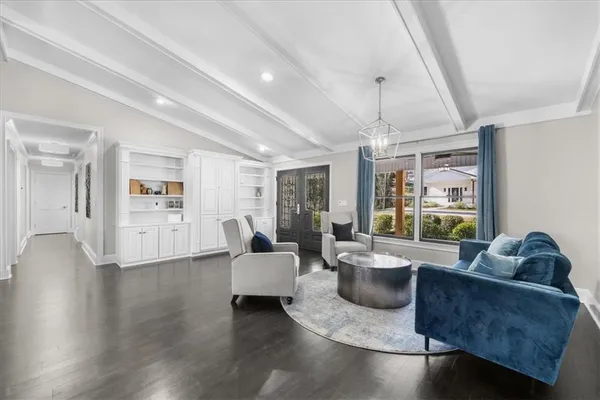 a living room with furniture and a wooden floor