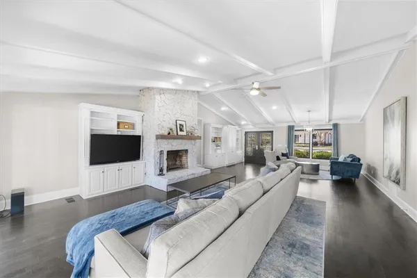a kitchen with stainless steel appliances granite countertop a sink and a white cabinets