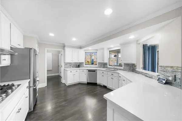 a large bedroom with a large bed and a chandelier