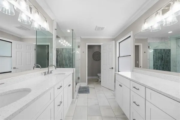 a view of an empty room with wooden floor and a fireplace