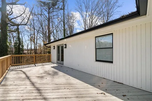 a aerial view of a house next to a big yard and large trees