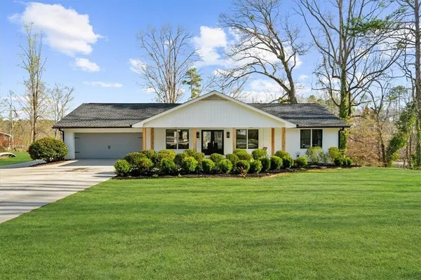a living room with furniture and a table with wooden floor