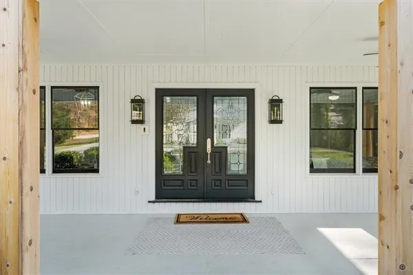 a living room with furniture a large window and a fireplace