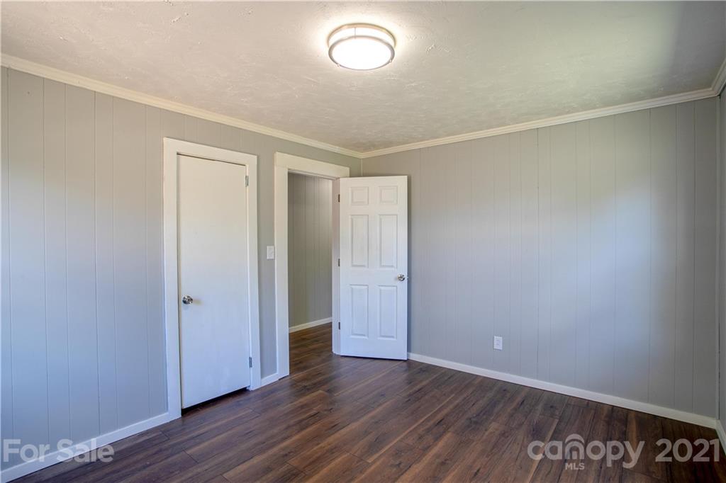 124 Harris Street Rutherfordton, NC 28139 - Photo 14 of 33 an empty room with wooden floor and windows