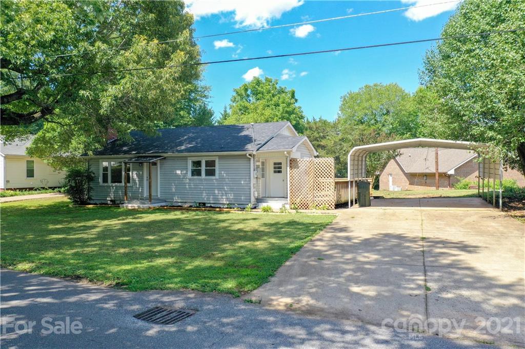 124 Harris Street Rutherfordton, NC 28139 - Photo 22 of 33 a front view of a house with a yard and garage