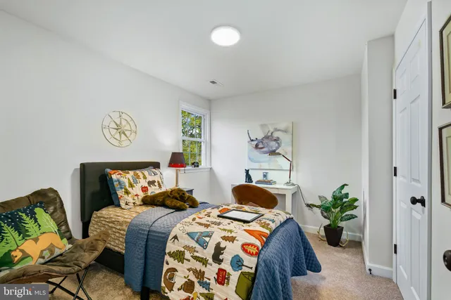 a bedroom with bed and a window