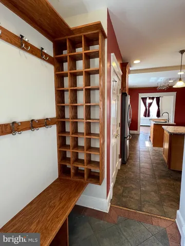 an empty room with wooden floor a fireplace and windows