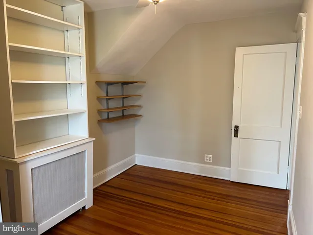 a front view of a house with a garden and yard